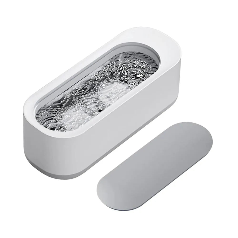White ultrasonic cleaner with lid.