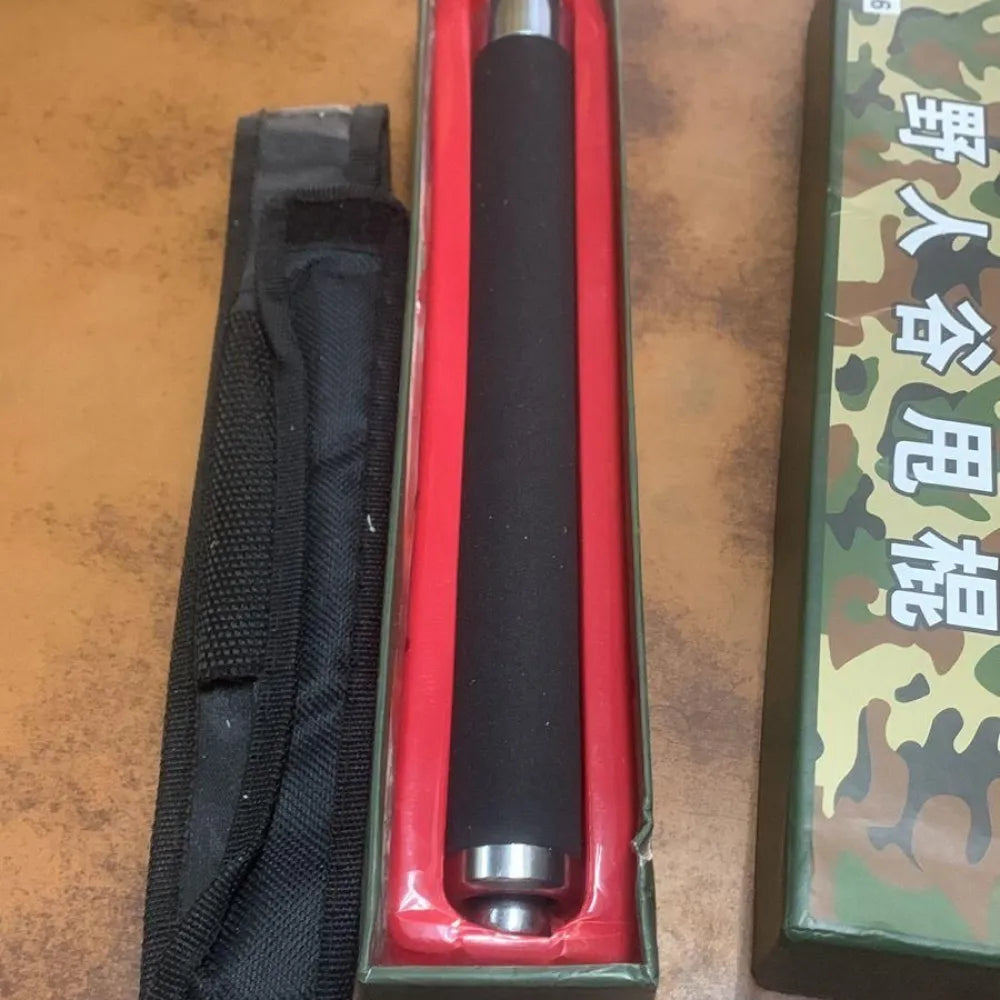 Black expandable baton in box.
