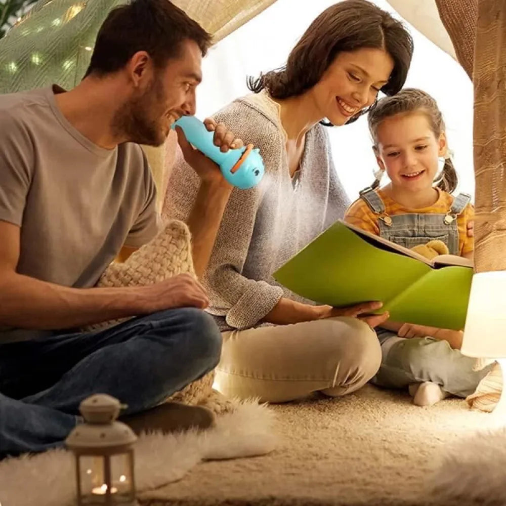 Family reading a book in a tent.