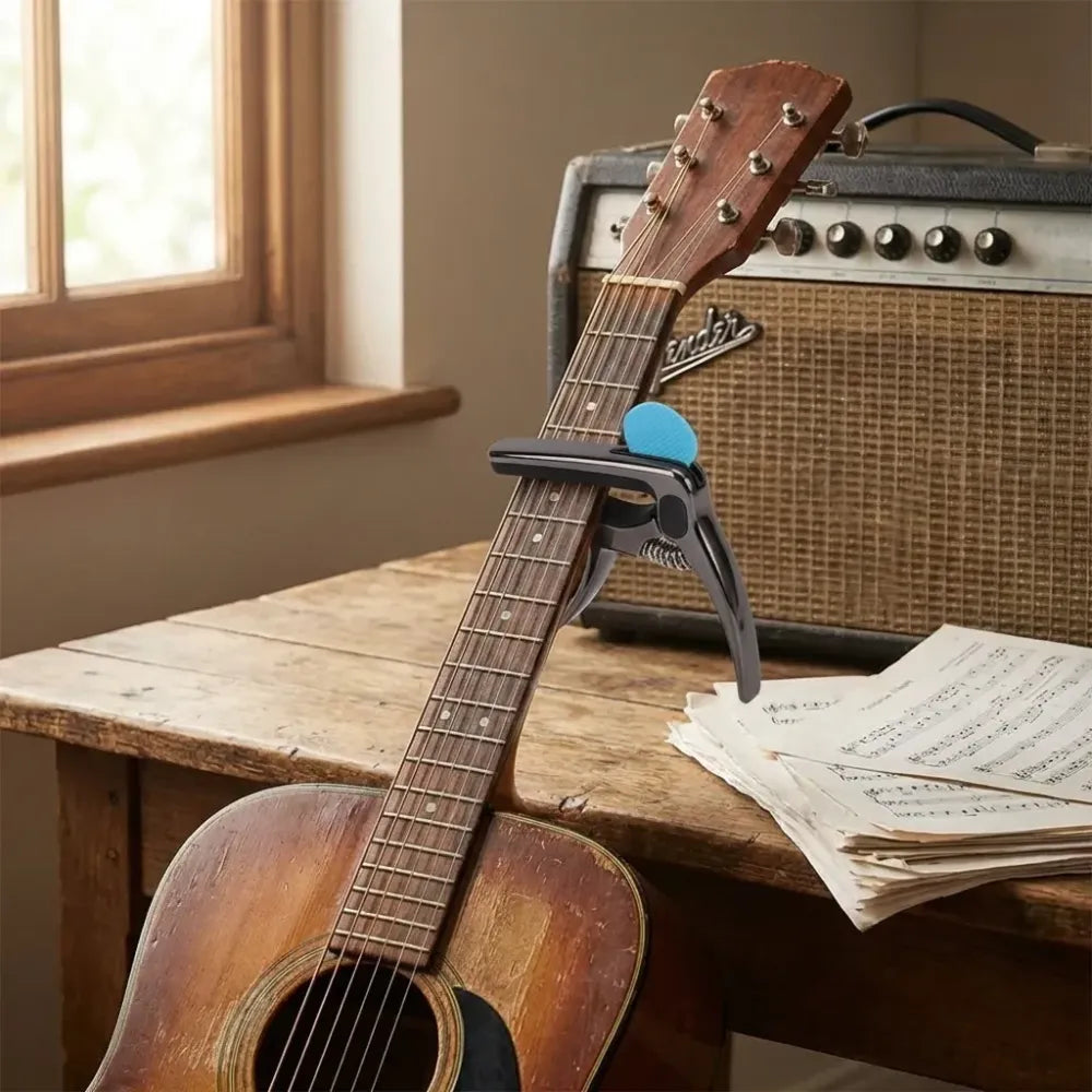 Guitar capo with pick holder - home improvement