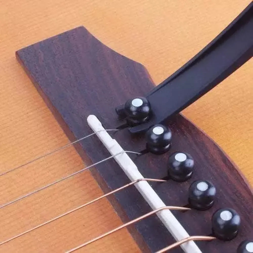 Guitar capo with pick holder