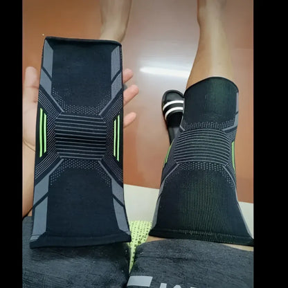 Black and gray knee brace with green accents.