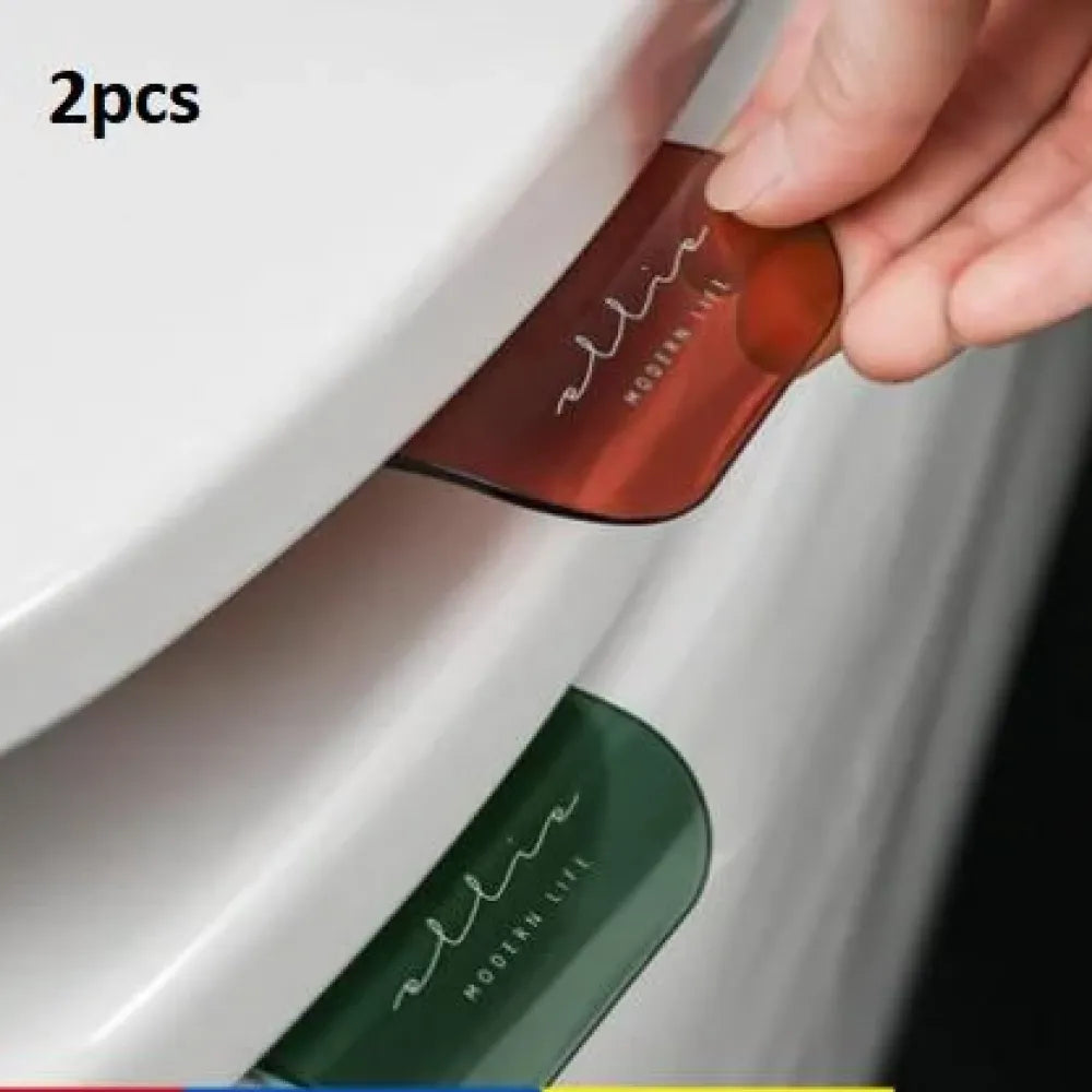 No-touch toilet seat lifters