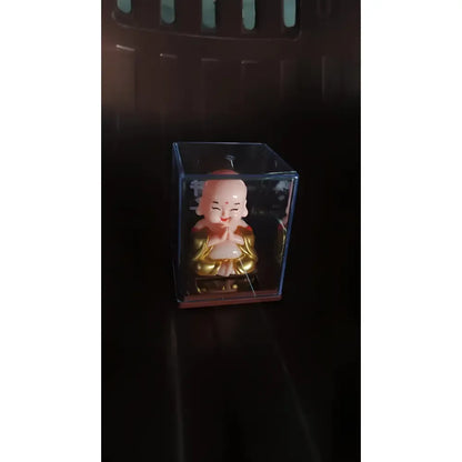 Solar-powered nodding buddha ornament - automotive